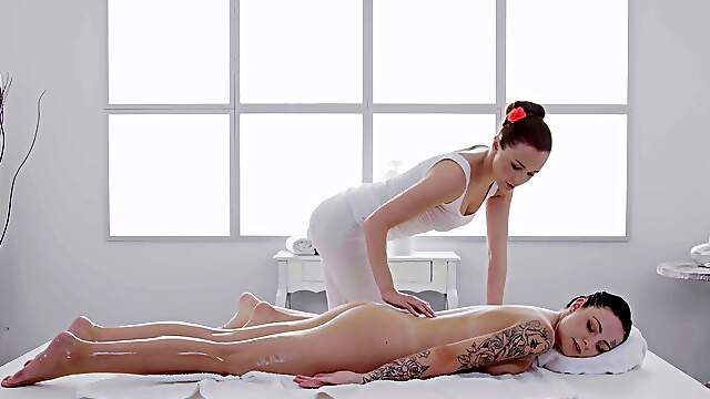 Nude dolls play together on the massage table in energized oral duo