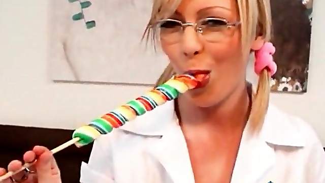 Schoolgirl in glasses sucks on a lollipop