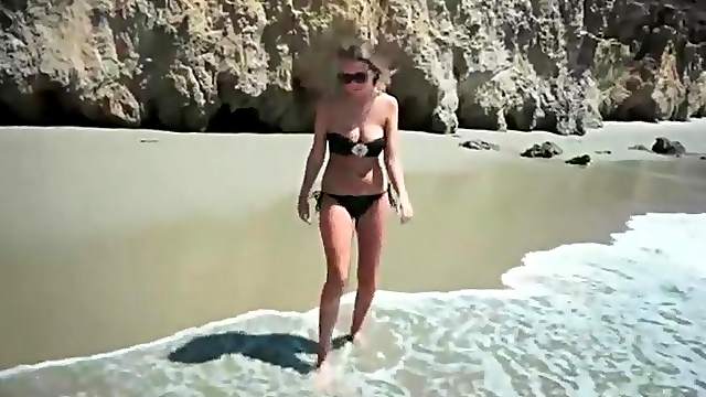 Alexis Adams plays on the beach in her bikini