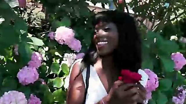 Black girl in the garden shows her pussy upskirt